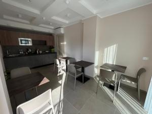 - une cuisine et une salle à manger avec deux tables et des chaises dans l'établissement Residenza Elba - Charme House, à Termoli