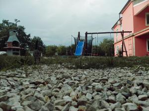 a large pile of rocks next to a playground at Apartman MR in Potpićan