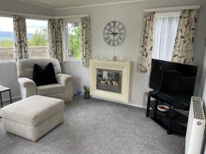a living room with a chair and a fireplace at Pendle Hill View in Preston