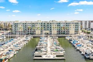 a bunch of boats docked in a marina with a building at Emerald Gem 2bedroom 2bath With Full Marina View in Los Angeles