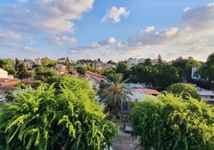 uitzicht op een stad met bomen en gebouwen bij Spacious 3BD Penthouse with Rooftop & Parking in Ra‘ananna