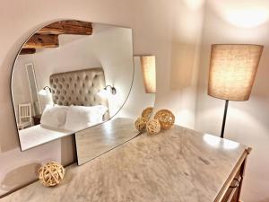 a bedroom with a mirror and a dressing table at Hotel Lauri in Macerata