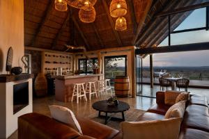 a living room with a couch and a table at Elephants Crossing in Welgevonden Game Reserve