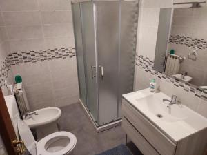 a bathroom with a shower and a toilet and a sink at Casa Giò in Lido di Ostia