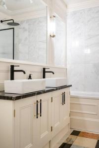 a white bathroom with two sinks and a tub at Spacious 2 Bed Luxury Apartment in Kent