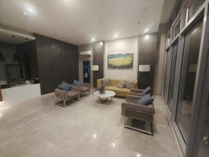 a living room with a couch and chairs and a table at Best inn CEBU Avida Riala Tower 3 209 in Cebu City