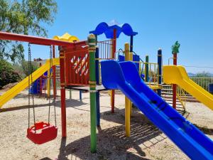 a playground with colorful slides and swings at Kalkan Centre Bijou Home - Walk to town and beach in Kalkan