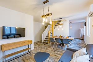 een woonkamer en eetkamer met een bank en een tafel bij Centre Historique - FREE Parking - Self Checkin - WIFI - LA CABANE - SLEEPNTRIPBEZIERS in Béziers
