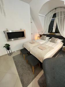 a bedroom with a large bed and two chairs at Salt INN Apartments No 1 in Wieliczka