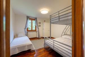 a bedroom with two bunk beds and a window at Villa Degli Olivi is located in Saragano in Saragano