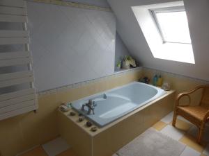a bath tub in a bathroom with a window at LA MARNE TRANQUILLE in Le Perreux-Sur-Marne