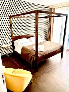 a bedroom with a bed with a wooden frame at TorreNormanna Prestige House near Cefalù in Mandra Capreria