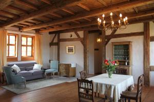 a living room with a table and a couch at Domherrenhaus Meissen in Meißen