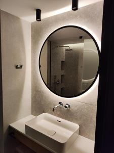 a bathroom with a sink and a mirror at Ammos Paleochora Hotel in Palaiochora