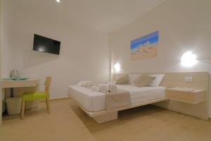 a bedroom with a bed and a desk and a television at Stella del Capo 3 stelle Affittacamere in San Vito lo Capo