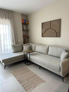 a living room with a couch and a table at Suit Apartment Golem, Durres in Golem
