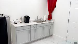 a kitchen with a sink and a red curtain at Cozy Studio…5 min away from LAS Airport. “ in Las Vegas