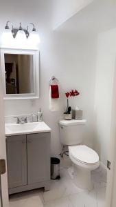 a bathroom with a toilet and a sink and a mirror at Cozy Studio…5 min away from LAS Airport. “ in Las Vegas