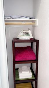 a shelf with a phone on top of it at Cozy Studio…5 min away from LAS Airport. “ in Las Vegas