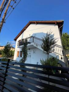 a white house with stairs leading up to it at Rock Hostel in Pristina