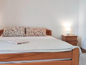 a bedroom with a bed with a pillow and a nightstand at MM Apartments in Budva