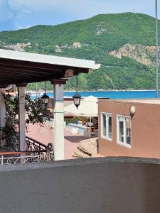 a resort with a view of a beach and a building at MM Apartments in Budva