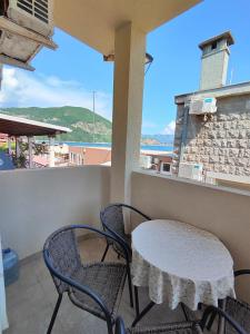 a patio with a table and chairs on a balcony at MM Apartments in Budva