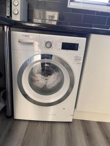 a washer and dryer sitting in a kitchen at Spacious and comfy in Woolwich