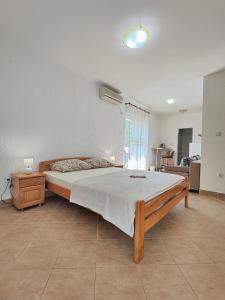 a bedroom with a large bed in a room at MM Apartments in Budva