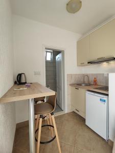 a kitchen with a wooden table and a counter at MM Apartments in Budva