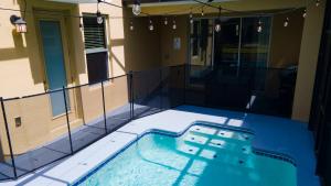 a swimming pool in front of a building at Thematic Home with Pool Spa and Game room! in Kissimmee