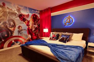a bedroom with a superhero mural on the wall at Thematic Home with Pool Spa and Game room! in Kissimmee
