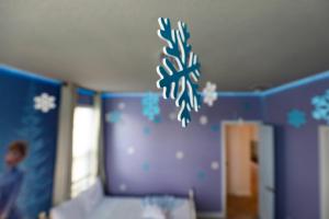a childs bedroom with a snowflake mural on the wall at Thematic Home with Pool Spa and Game room! in Kissimmee