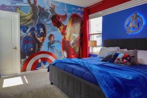 a bedroom with a superhero mural on the wall at Thematic Home with Pool Spa and Game room! in Kissimmee