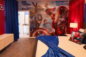 a bedroom with a superhero mural on the wall at Thematic Home with Pool Spa and Game room! in Kissimmee