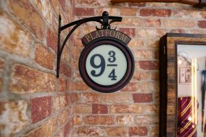 a clock hanging on a brick wall at Thematic Home with Pool Spa and Game room! in Kissimmee
