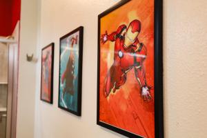 a framed picture of a spider man on a wall at Thematic Home with Pool Spa and Game room! in Kissimmee