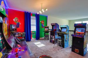 a room with arcade games and other games in it at Thematic Home with Pool Spa and Game room! in Kissimmee