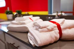 a group of towels on a counter in a kitchen at Thematic Home with Pool Spa and Game room! in Kissimmee