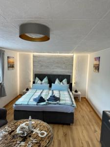 Schlafzimmer mit einem blauen Bett und einem Tisch in der Unterkunft Zum Segler in Rostock