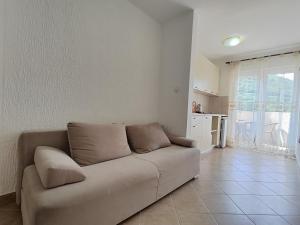 a living room with a couch and a kitchen at MM Apartments in Budva