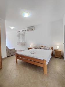 a bedroom with a bed and a couch in it at MM Apartments in Budva