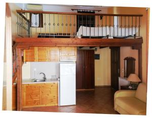 a kitchen with a loft bed with a sink and a refrigerator at Dallia Loft Space in Goumenissa