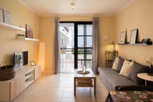 a living room with a couch and a tv at Tyler's House Ocean View in Costa Teguise