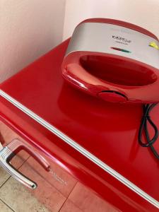 a red and white toilet sitting on a red table at Chales Sitio dos Ventos in Lavras Novas