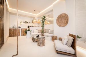 a living room with a couch and a table at Gèa Athenian Suites in Athens
