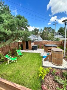 a backyard with a table and chairs and a barrel at Projekt Warchały in Warchały