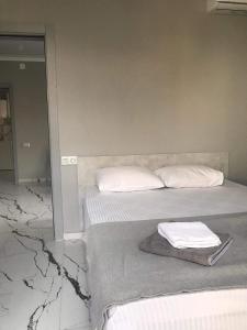 - une chambre avec 2 lits dotés d'oreillers blancs dans l'établissement Guesthouse Data, à Gonio