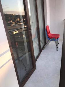 a red chair sitting next to a window at Guesthouse Data in Gonio