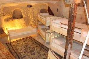 a room with a wooden floor and a wooden floor at Stay In Peace Cave Hostel in Göreme